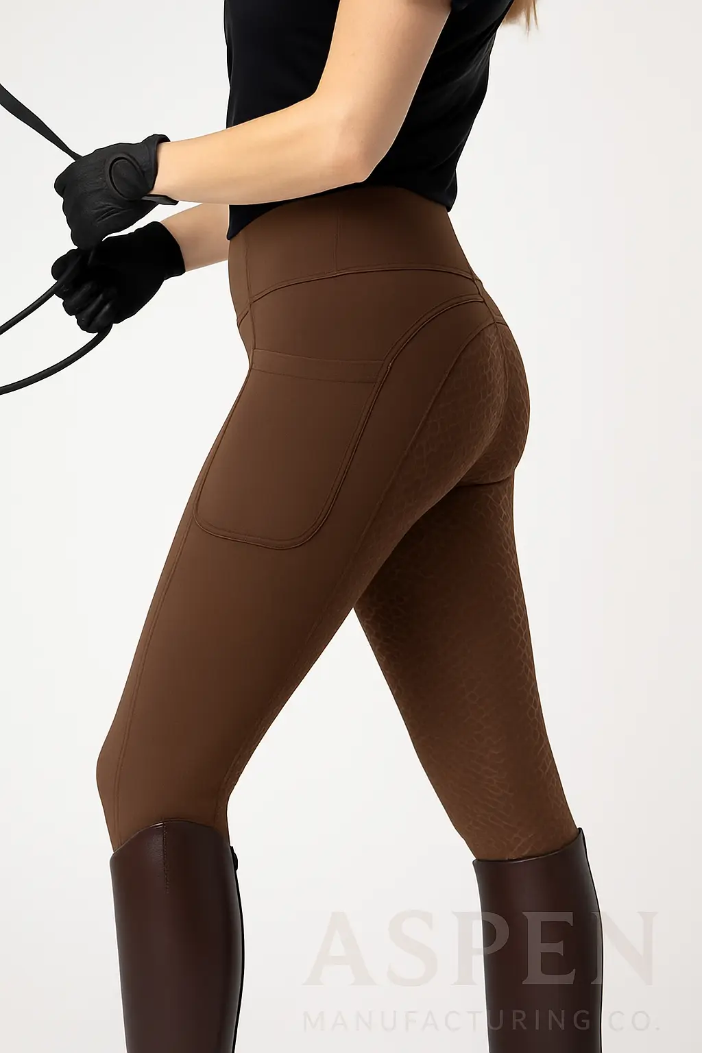 Woman in high-waisted brown horse riding leggings with textured grip panels