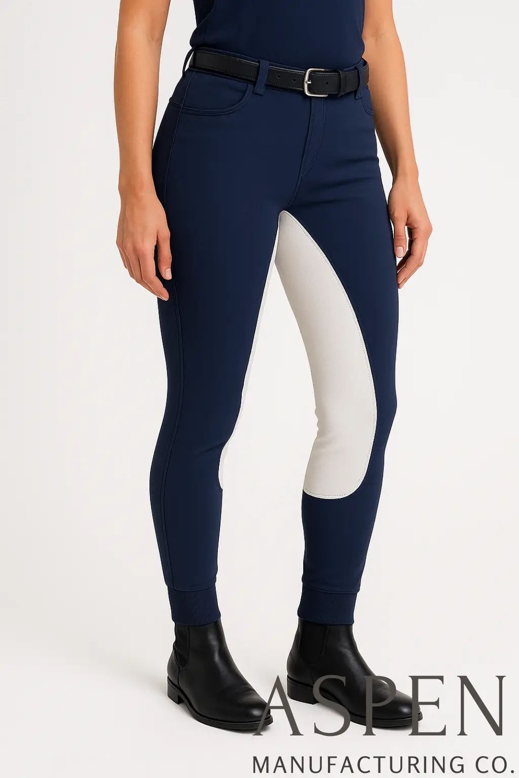 Woman wearing navy jodhpurs with white knee patches.